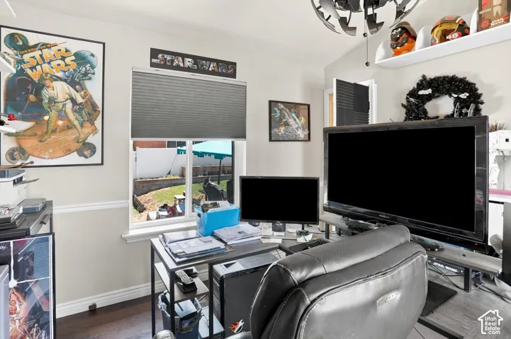 Hardwood-finish flooring, white wall paint, window with horizontal blinds, backyard visible, wall-mounted shelving