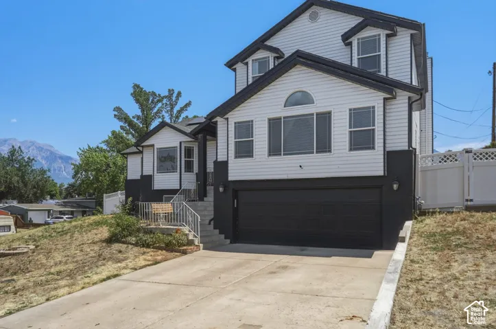 Two-story residence with white siding and dark trim