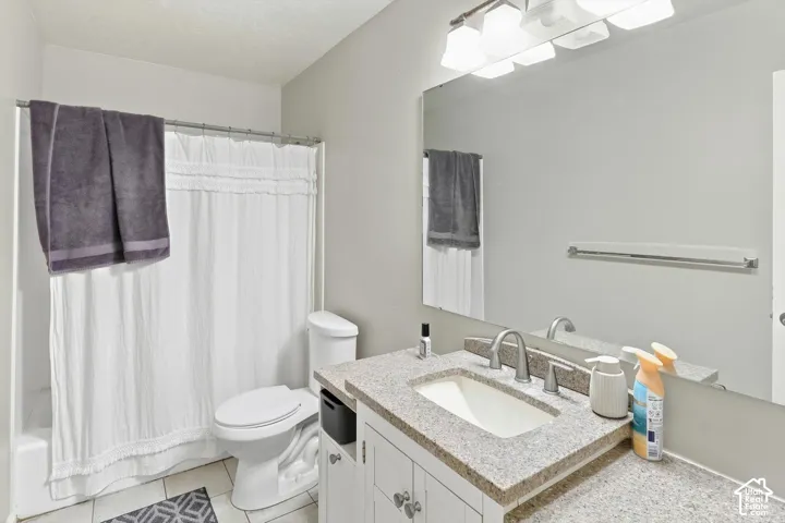 Vanity with a built-in sink, brushed nickel faucet, and a large mirror