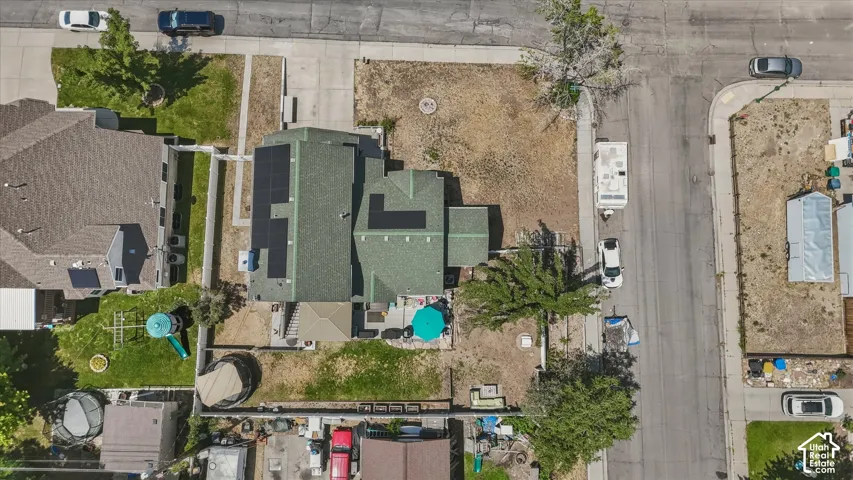 Green shingle roof with multiple solar panel installations