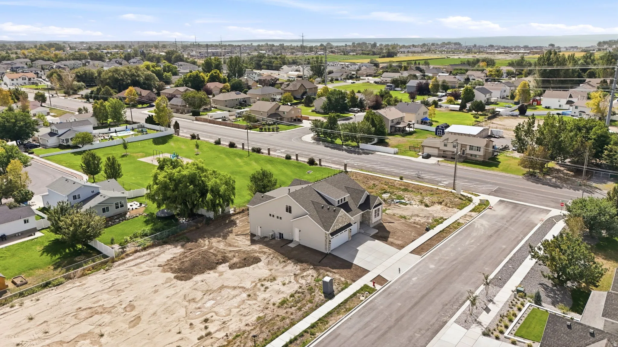 Newly constructed residence with a light-colored exterior and a multi-gabled roof