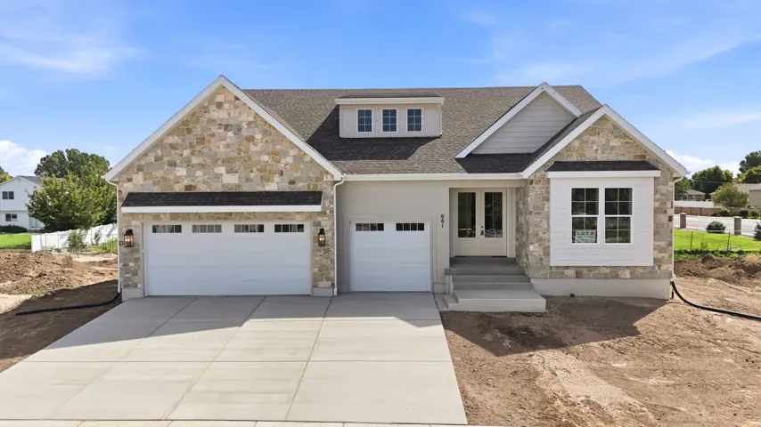 Stone and stucco exterior with dormer window detail