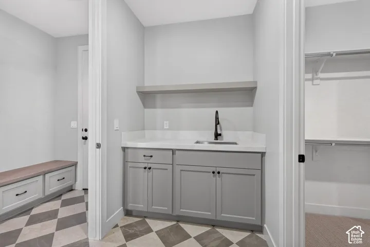 Laundry room connects to primary closet and mud room