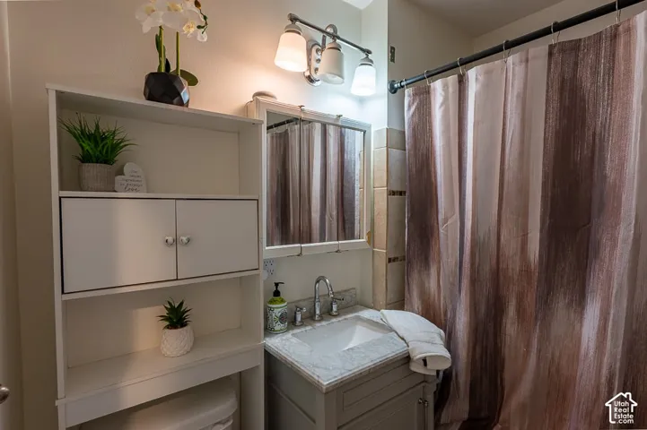 Full bathroom with vanity and tub/shower combo included.