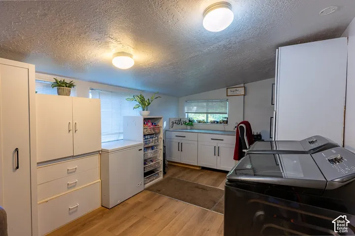This flexible space behind the kitchen isn't just a laundry room. Offering extra storage and space to sit or set up a home office.