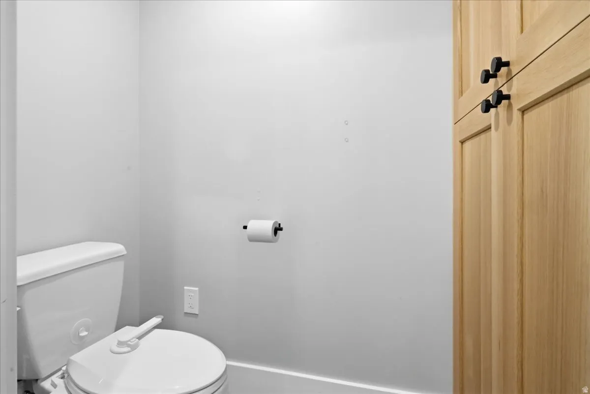 White toilet fixture with a bidet attachment