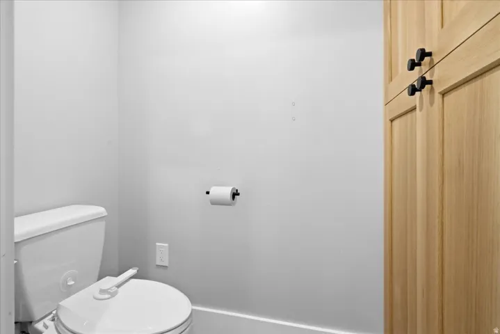 White toilet fixture with a bidet attachment