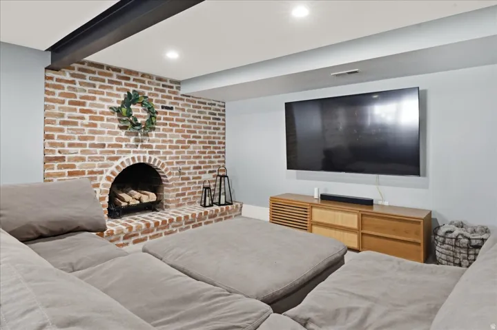 Exposed brick fireplace with an arched firebox