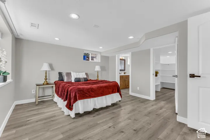 Spacious primary suite with a large walk-in closet, private ensuite bath, and oversized window that fills the room with natural light.