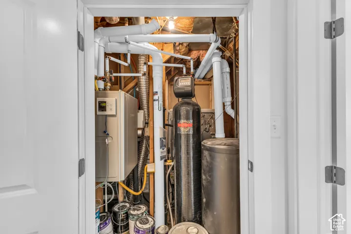 Utilities are tucked under the stairs. Tankless water heater, water softener, radon mitigation system, and furnace.