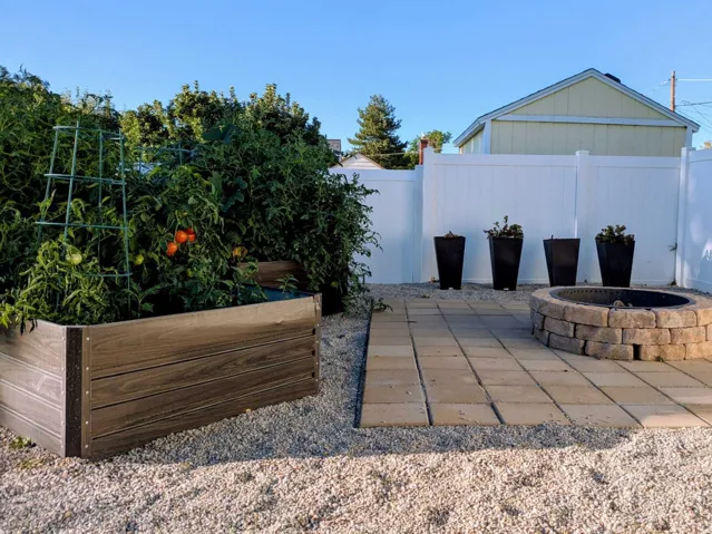 From roasting marshmallows around the firepit to harvesting fresh vegetables from your own garden, this backyard is designed to be enjoyed. Raised garden beds with drip irrigation are already producing tomatoes, cucumbers, zucchini, and yellow squash, so
