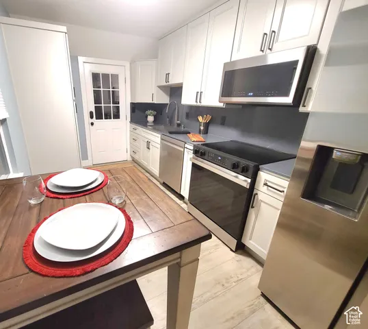 Whether you prefer a cozy breakfast nook or a formal dining table, this flexible layout gives you the option of both. The updated kitchen features stainless steel appliances, stylish finishes, and plenty of storage.