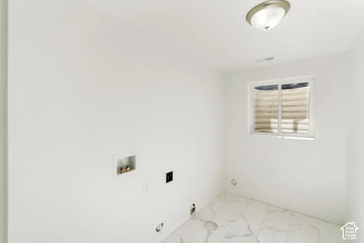 White walls, window, ceiling light fixture, and white tile flooring