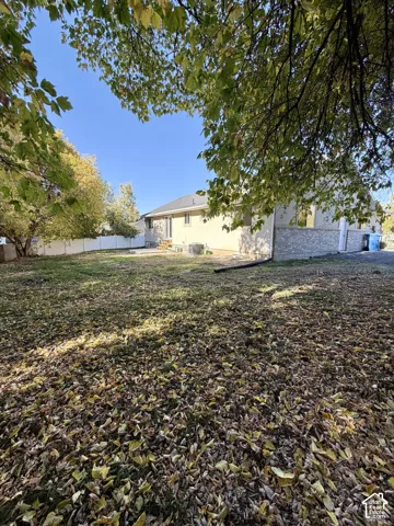 Spacious grounds featuring mature shade trees and a generous lawn area