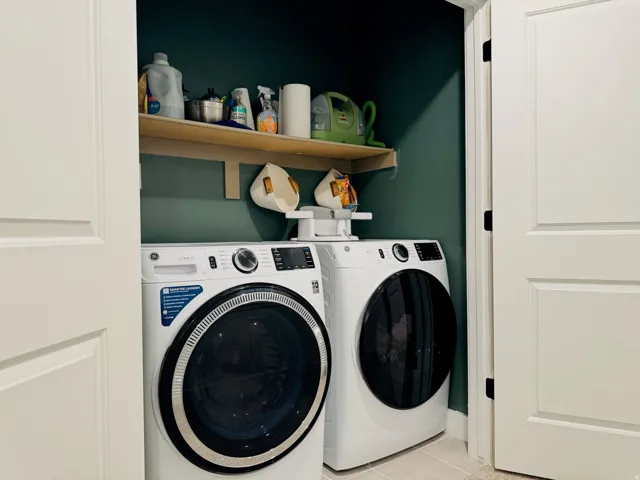 Laundry area with shelving and tile flooring