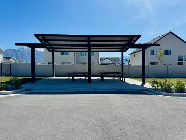 Covered patio structure with a flat roof and concrete pad