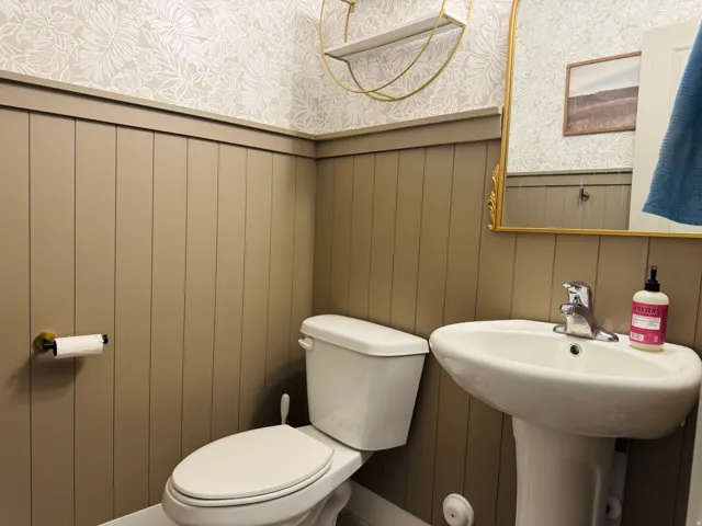 Vertical paneling wall treatment with decorative trim