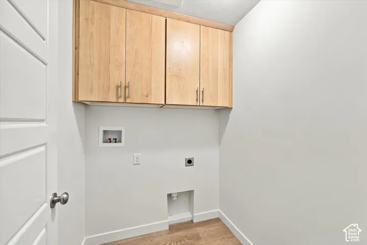 Natural wood-finish cabinetry with brushed nickel hardware