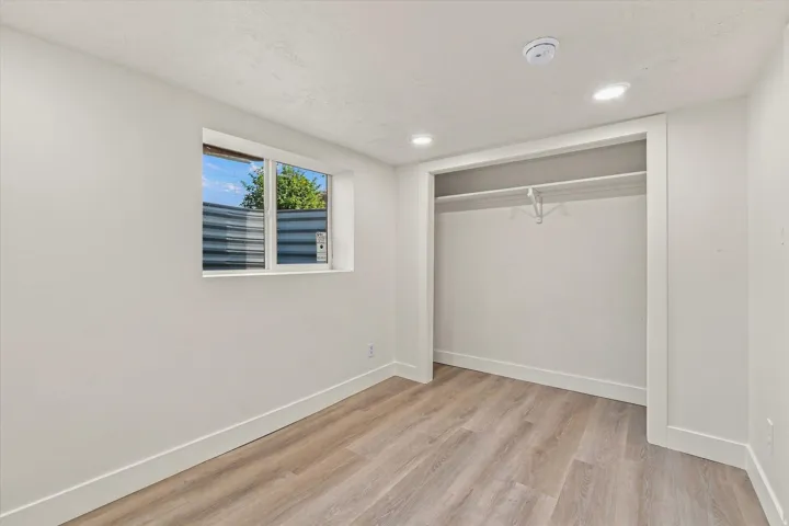 Recessed lighting illuminates the space, complemented by wood-finish flooring