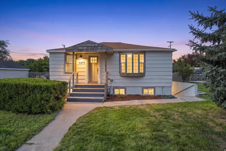 Siding exterior, bay window, covered entry, front walkway, and concrete steps
