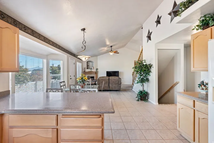 Kitchen. Tile floors. Vaulted Ceilings. Large windows. White appliances. Pantry.