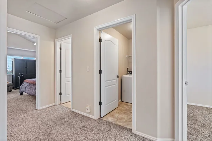 Hallway; leading to full bath, laundry, bedrooms 2 and 3.