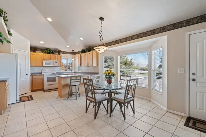Kitchen. Tile floors. Vaulted Ceilings. Large windows. White appliances. Pantry.