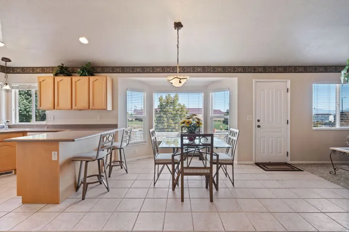 Kitchen. Tile floors. Vaulted Ceilings. Large windows. White appliances. Pantry.