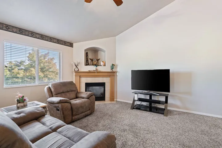 Open Concept. Vaulted Ceilings. Carpet. Tile. Large windows. Gas Fireplace.