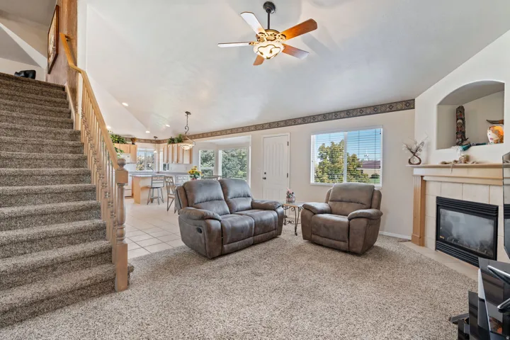 Stairs to bonus room above garage. Open Concept. Vaulted Ceilings. Carpet. Tile. Large windows. Gas Fireplace.