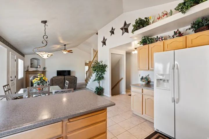 Kitchen. Tile floors. Vaulted Ceilings. Large windows. White appliances. Pantry.