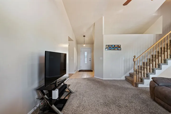 Open Concept. Vaulted Ceilings. Carpet. Tile. Large windows. Gas Fireplace.
