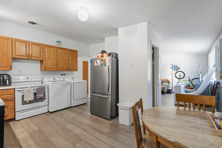 Wood-finish flooring, wood cabinetry, and a white range