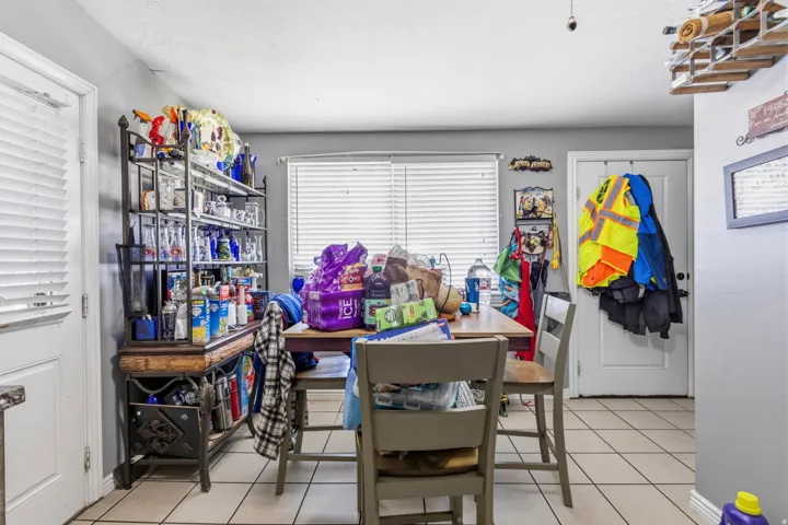 Tile flooring, white window blinds, and interior doors