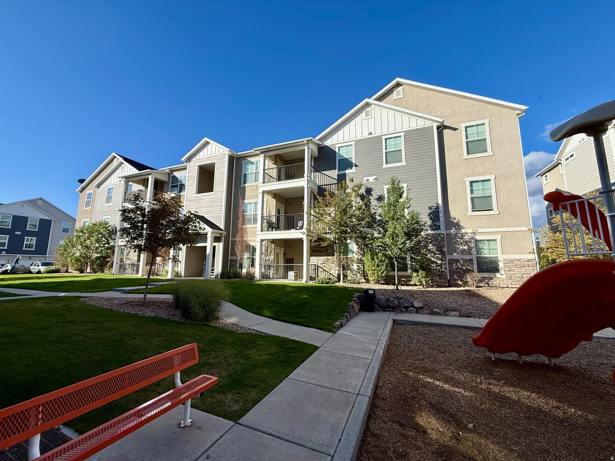 Exterior features include balconies, multiple windows, and a mix of siding and stucco finishes