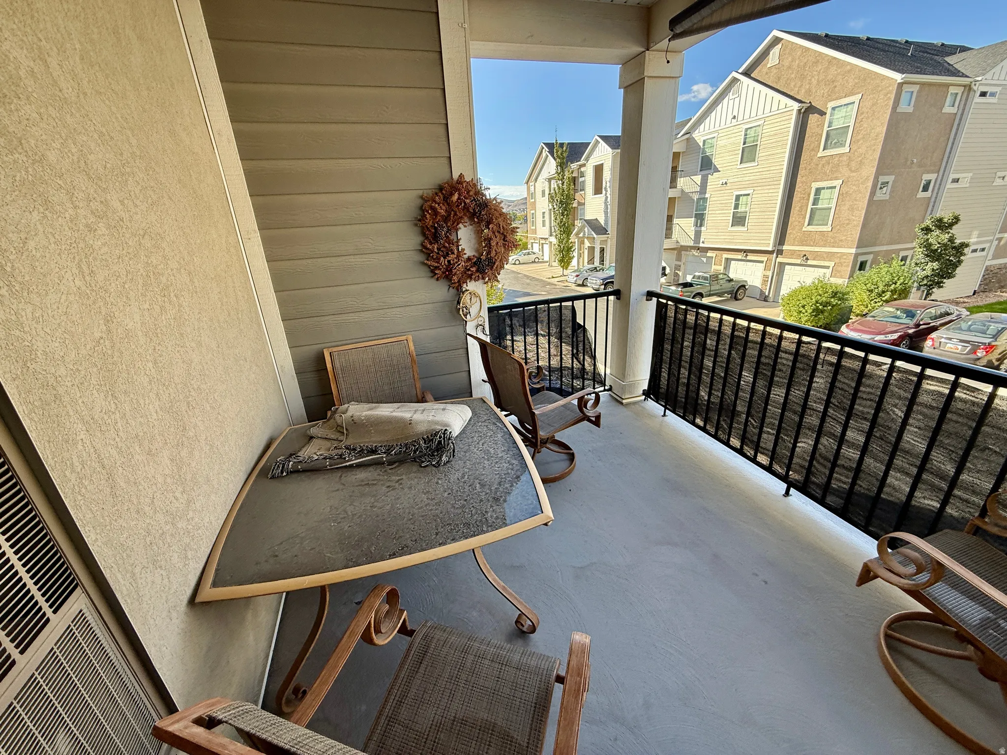 Private balcony with concrete flooring and black metal railings