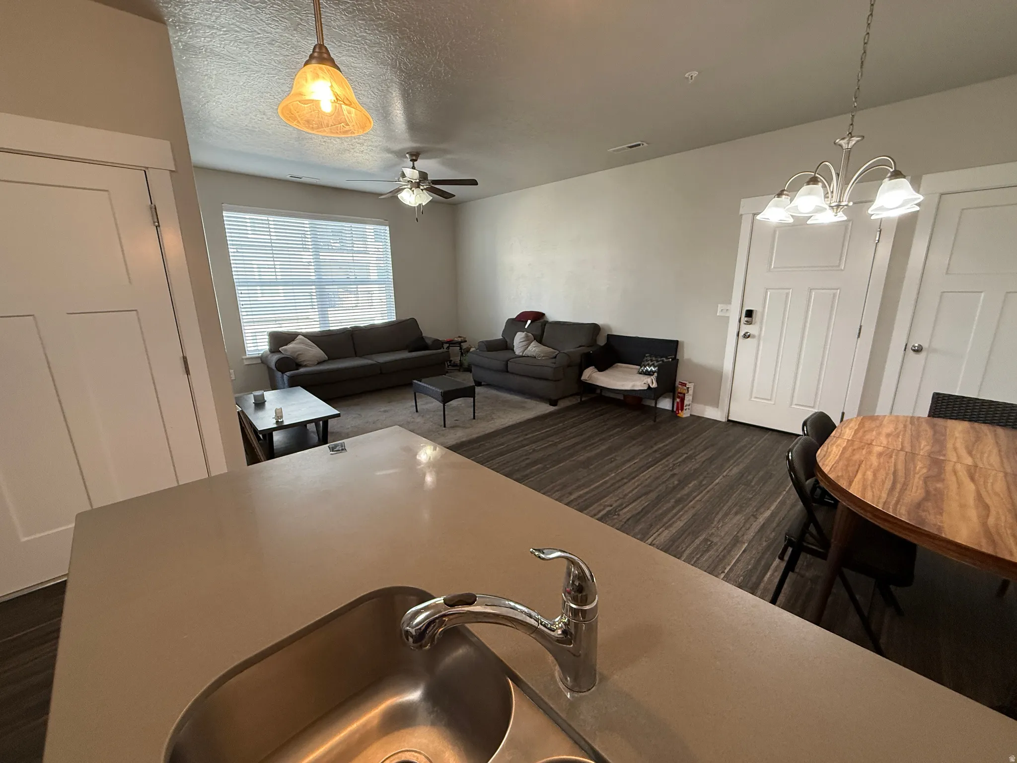 Kitchen peninsula with an integrated stainless steel sink and chrome faucet