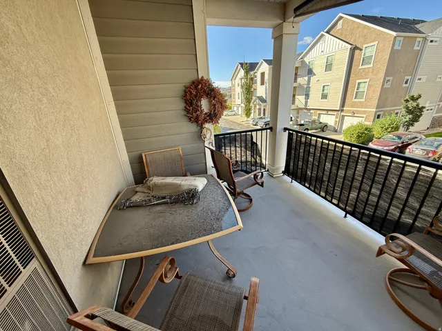 Private balcony with concrete flooring and black metal railings