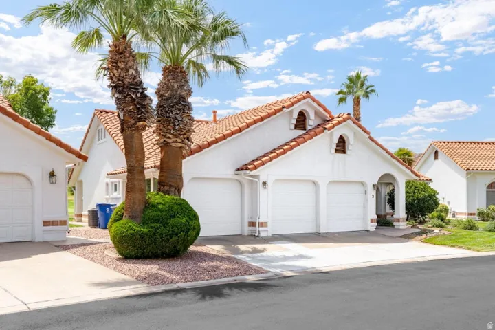 White stucco exterior with a terra cotta tile roof