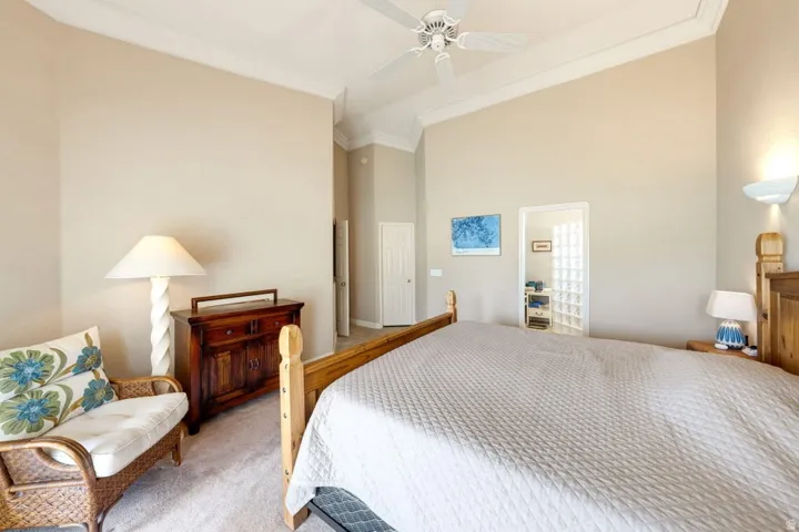Vaulted ceilings featuring crown molding, recessed lighting, and a ceiling fan