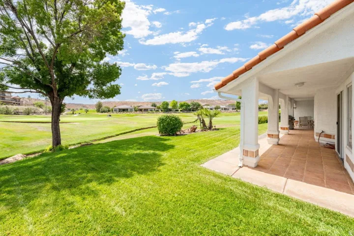 Covered patio with terracotta-style tile flooring and stucco columns