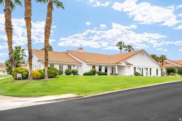 White stucco exterior with a terra cotta tile roof