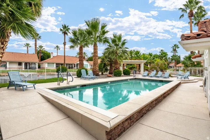 Outdoor swimming pool with integrated steps, surrounded by a concrete deck