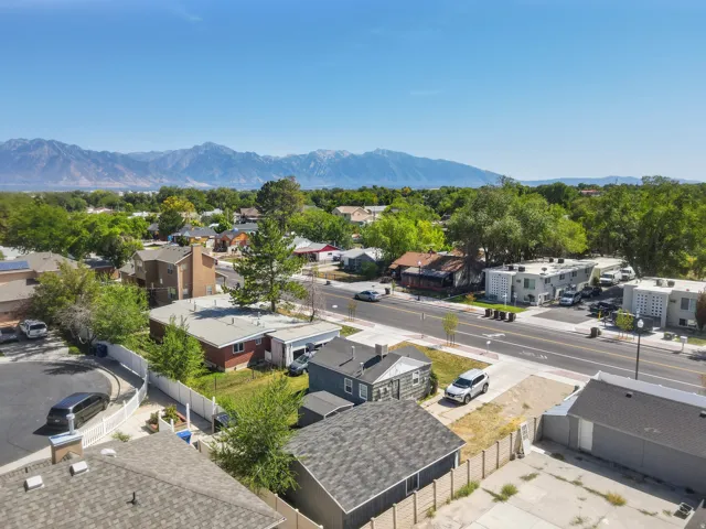 Mountain backdrop with extensive residential development, mature trees, and a visible roadway