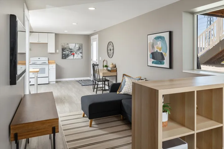 Open-concept living area with light wood-finish flooring