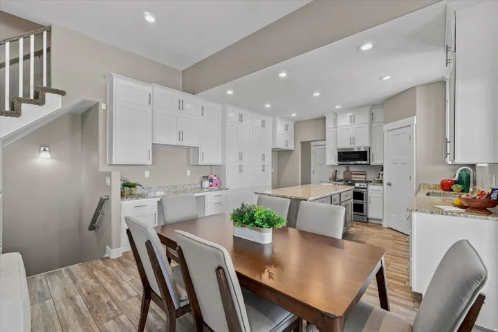 Open-concept kitchen with white cabinetry and an island with seating