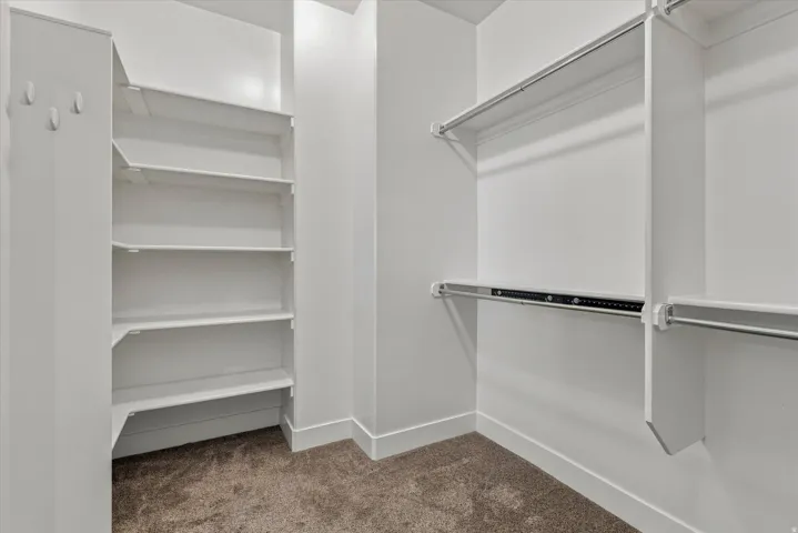 Integrated shelving system, multiple hanging rods, and carpet flooring