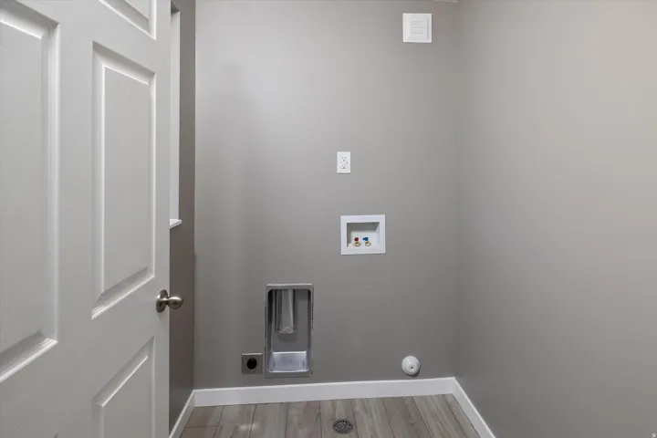 Panel doors, wood-finish flooring, and light gray walls