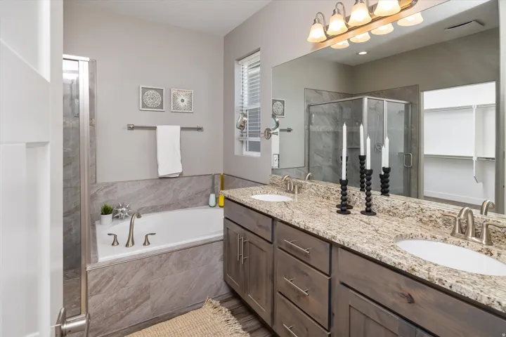 Dual vanity with integrated sinks, brushed nickel faucets, and a speckled countertop