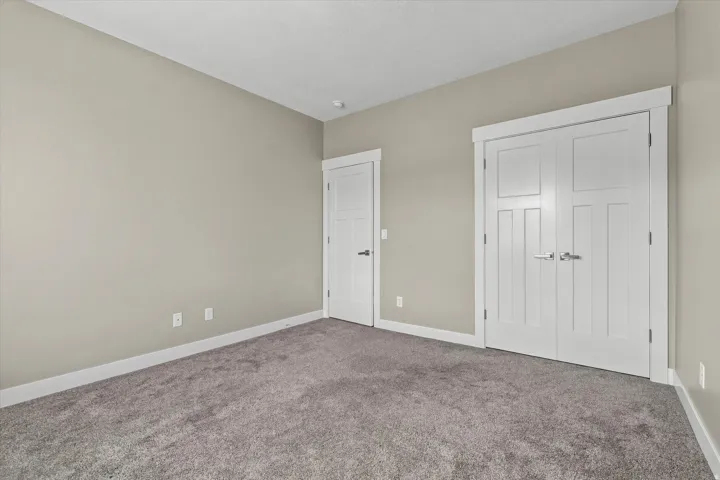 Grey wall-to-wall carpeting with light grey wall paint